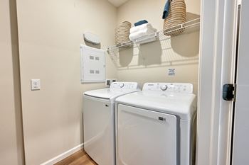 A small laundry room with a washer and dryer.